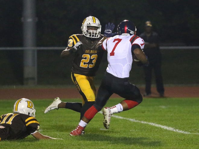 Willingboro's Ricardo Patterson tries to escape the defense of Delran's Charles Hall during a game earlier this year.