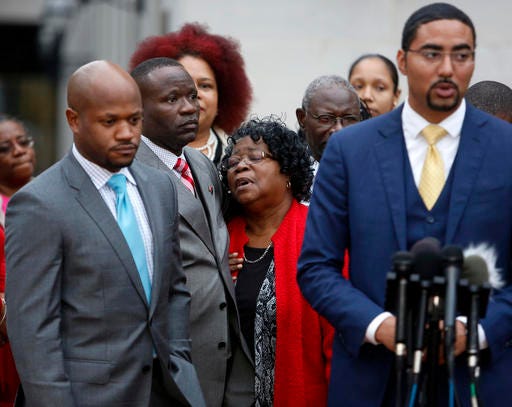 Judy Scott, center, Walter Scott's mother, is comforted by her son Rodney Scott, as the family attorneys, Chris Stewart, left, and Justin Bamberg, right, hold a press conference after the mistrial was declared for the Michael Slager trial Monday Dec. 5, 2016, in Charleston, S.C. Former patrolman, Slager, is charged with murder in the shooting death of Walter Scott last year. (AP Photo/Mic Smith)