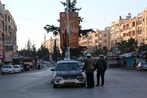 In this Tuesday, Dec. 6, 2016 photo, Syrian traffic policemen direct traffic in the western city of Aleppo, Syria. Aleppo shakes with explosions and gunfire day and night in both the government and rebel sides. But for supporters of President Bashar Assad at least, there is comfort in the growing sense of imminent victory in the city. A rebel defeat in Aleppo, Syria’s largest city and former commercial center, is likely to reverberate across the war-torn country, where opposition forces continue to hold out in smaller, more disconnected areas. (AP Photo/Hassan Ammar)