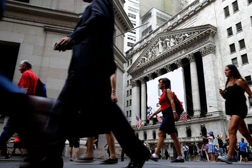 FILE - In this Monday, Aug. 24, 2015, file photo, pedestrians walk past the New York Stock Exchange. On Thursday, Dec. 8, 2016, the Federal Reserve reports on household wealth for the July-September quarter. (AP Photo/Seth Wenig, File)