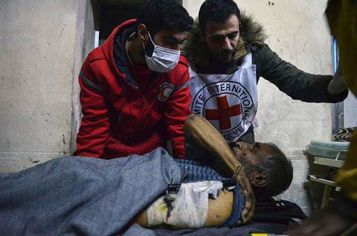 This Wednesday, Dec. 7, 2016 photo, released by the International Committee for the Red Cross, shows members of the Syrian Arab Red Crescent laying a patient on stretcher after taking him out of a medical facility in the Old City of Aleppo, Syria. The ICRC said it evacuated 148 disabled or civilians in need of urgent care from the facility, now under Syrian government control. ICRC said in a statement Thursday the evacuation was possible after fighting calmed down in the area. (Syrian Arab Red Crescent/Noor Hazouri via AP)