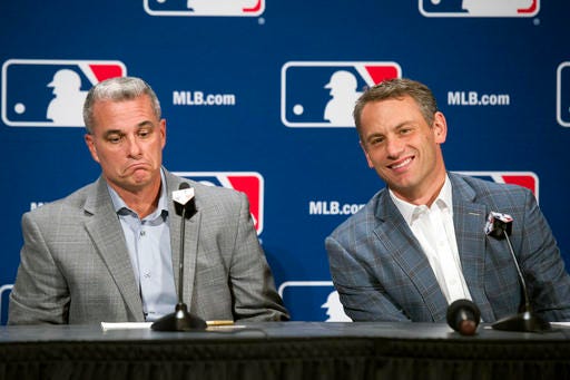 Kansas City general manager Dayton Moore, left, and Chicago Cubs general manager Jed Hoyer, announce a trade during Major League Baseball's winter meetings in Oxon Hill, Md., Wednesday, Dec. 7, 2016. The World Series champion Chicago Cubs have acquired star closer Wade Davis from the Kansas City Royals for outfielder Jorge Soler. (AP Photo/Cliff Owen)
