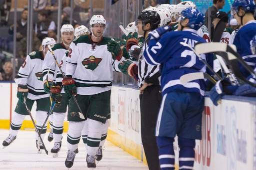 Minnesota Wild center Eric Staal, center, celebrates scoring against the Toronto Maple Leafs during the second period of an NHL hockey game in Toronto on Wednesday, Dec. 7, 2016. (Chris Young/The Canadian Press via AP)