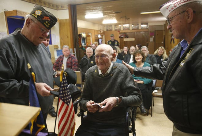 Ralph Kephart, center, a 102-year-old World War II Army veteran, is congratulated by Richard Eubank, left, a past Oregon/California and National VFW commander, and past Oregon commander Norm Henshen, right, after Kephart was inducted into the VFW. (Andy Nelson/The Register-Guard)