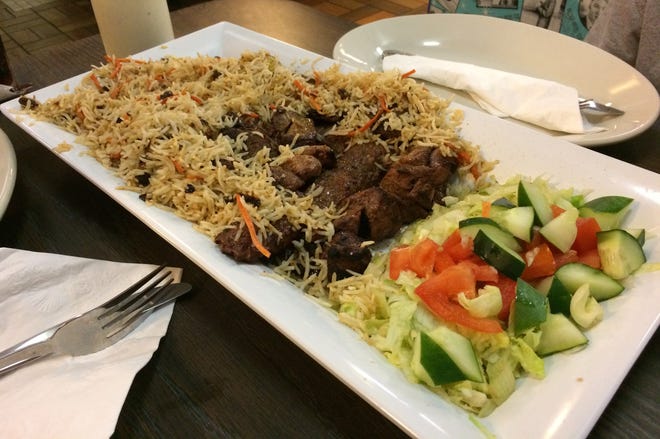 KK's Special Platter features lamb, beef and chicken kabobs with Afghani rice and salad to share at Kabob House in Panama City. JAN WADDY/THE NEWS HERALD
