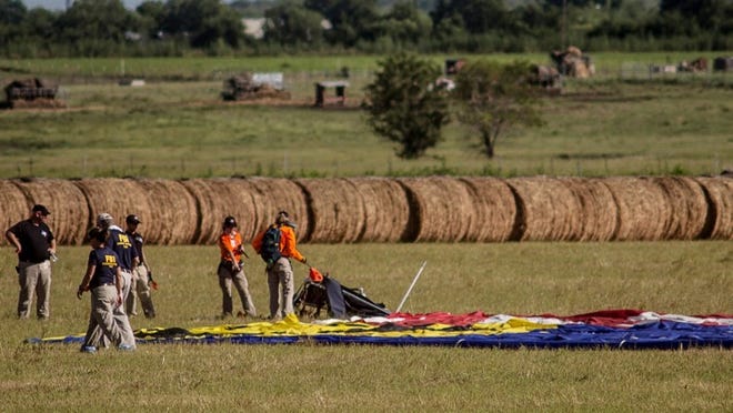 Investigators at the scene of the Lockhart balloon crash that killed 16 people.