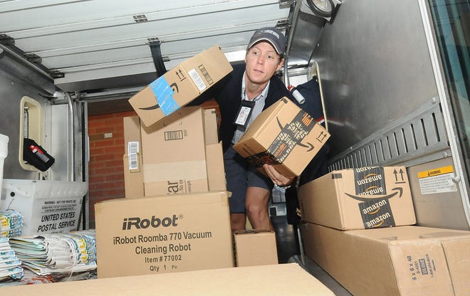 U.S. Postal Service worker Scott Shannon loads packages into his truck at the Maple Shade Post Office.