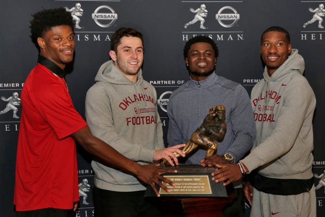 Heisman Trophy finalists, from left: Louisville’s Lamar Jackson, Oklahoma’s Baker Mayfield, Michigan’s Jabrill Peppers, and Oklahoma’s Dede Westbrook, poses with the award in New York, Friday, Dec. 9, 2016. (Richard Drew/AP Photo)