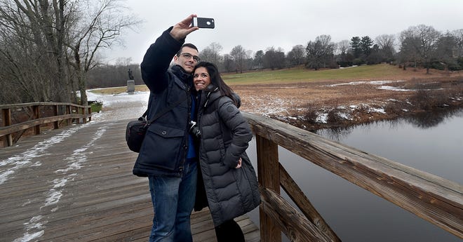 Tourists Ignacio Rodriguez and Mary Cabezas of Madrid, Spain, pose for a selfie on Concord's North Bridge Wednesday during a visit to Minute Man National Historical Park in Concord. DAILY NEWS STAFF PHOTO BY KEN MCGAGH