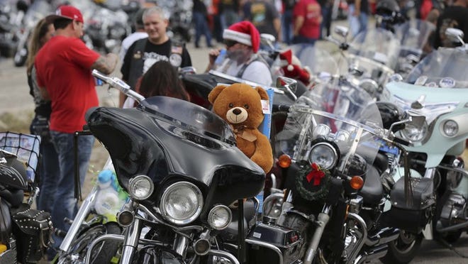 Motorcyclists participating in the 33rd Annual Bill’s Bikes Memorial Toy Run assemble at the South Florida Fairgrounds Sunday, Dec. 13, 2015, for a police-escorted parade to Dreher Park. The event brings in donations for Toys for Tots. The threat of rain has canceled Sunday’s 34th run, although organizers will collect toys at the South Florida Fair. (Bruce R. Bennett / The Palm Beach Post)