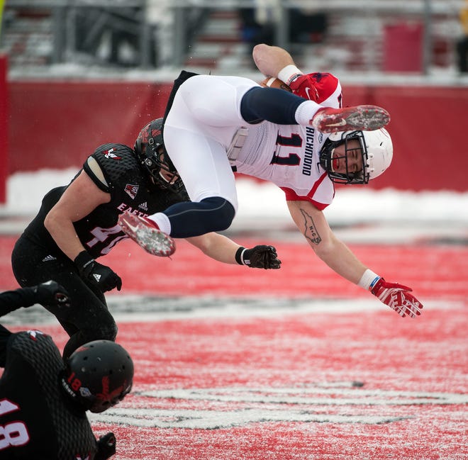 Richmond tight end Garrett Hudson (11) is tacked for a gain of less than a yard by Eastern Washington linebacker Ketner Kupp (40) during the first half of a second-round FCS playoff game at Roos Field on Saturday Dec. 10, 2016, in Cheney, Wash. (Colin Mulvany/The Spokesman-Review via AP)