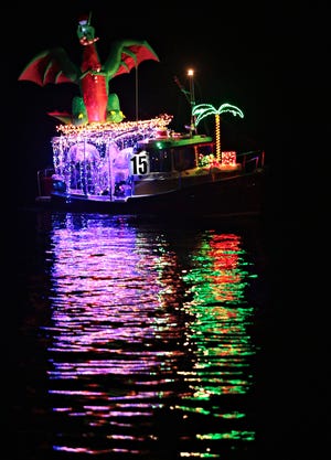 A dragon surfs a wave on the Barnacle II. Forty-three bedazzled vessels sailed past the Panama City Marina and the St. Andrews Marina during the 30th year of the Boat Parade of Lights on Saturday. HEATHER HOWARD/THE NEWS HERALD