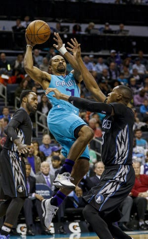 Charlotte Hornets guard Ramon Sessions, left, shoots over Minnesota Timberwolves forward Gorgui Dieng, of Senegal, in a NBA basketball game in Charlotte, N.C., Saturday, Dec. 3, 2016. (AP Photo/Nell Redmond)