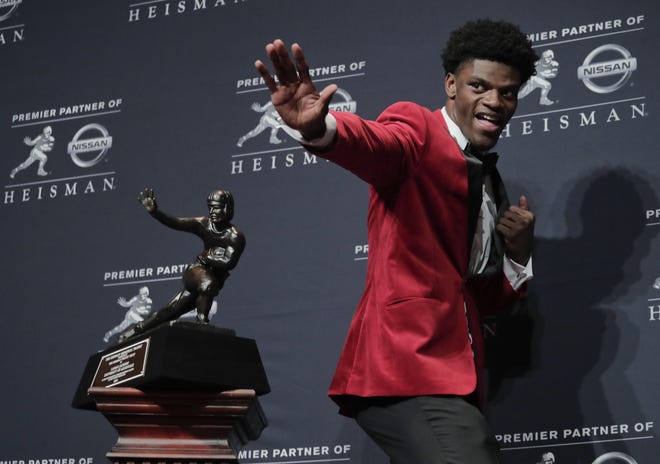 Louisville's Lamar Jackson poses with the Heisman Trophy after winning the award Saturday on Saturday night in New York.
