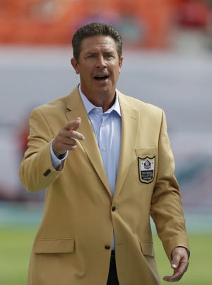 NFL Hall of Fame and Miami Dolphins player Dan Marino gestures before an NFL football game against the Minnesota Vikings, Sunday, Dec. 21, 2014, in Miami Gardens, Fla. (AP Photo/Wilfredo Lee)
