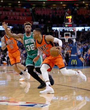 Oklahoma City Thunder guard Russell Westbrook (0) drives to the basket around Boston Celtics guard Marcus Smart (36) during the first half of an NBA basketball game in Oklahoma City, Sunday, Dec. 11, 2016. (AP Photo/Alonzo Adams)