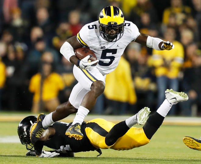 FILE - In this Nov. 12, 2016, file photo, Michigan’s Jabrill Peppers (5) breaks a tackle by Iowa defensive back Desmond King, rear, during the first half of an NCAA college football game, in Iowa City, Iowa. Peppers was selected to the 2016 AP All-America college football team, Monday, Dec. 12, 2016. (AP Photo/Charlie Neibergall, File)