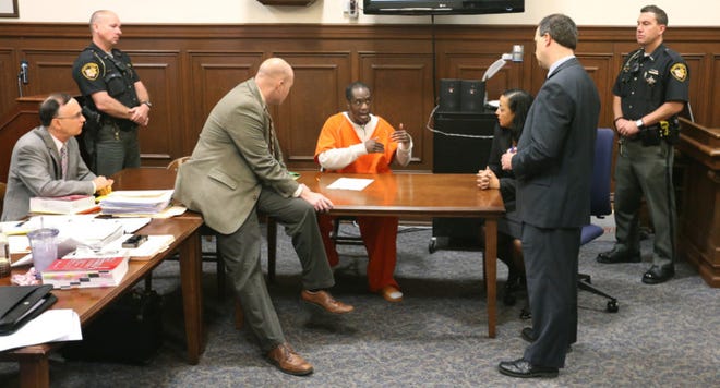 In this October 2015 file photo, Cuyahoga Falls Detective Chad Lengel (left) and Assistant Summit County Prosecutors John Galonski and Angela Alexander confer with defendant Jeffry Conrad, who is representing himself. At far left is Donald Hicks, a advisor to Conrad. Conrad is on trial for the stabbing death of his girlfriend Amanda Russell in August 2014. (Phil Masturzo/Akron Beacon Journal)