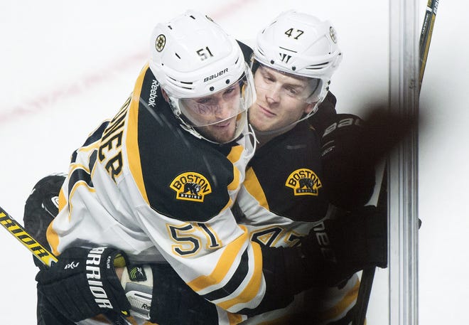Boston's Ryan Spooner (51) celebrates with teammate Torey Krug after scoring against the Montreal Canadiens during overtime on Monday night. AP Photo