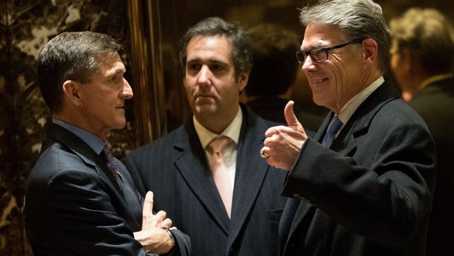 Retired Lt. Gen. Michael Flynn, left, President-elect Donald Trump’s choice for national security adviser, and Michael Cohen, executive vice president of the Trump Organization and special counsel to Donald Trump, talk with former Gov. Rick Perry in the lobby of Trump Tower on Monday.