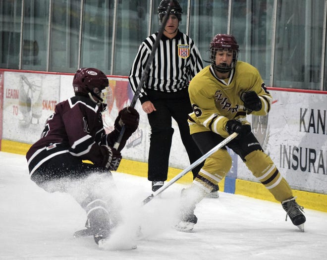 Portsmouth/Newmarket forward Andrew Weeks, right, chips a puck away from Goffstown's Nickolas Nault during Wednesday's Division II game at The Rinks at Exeter.
Photo by Mike Zhe/Seacoastonline