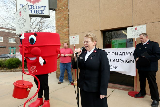 Major Penny Mungai offers a prayer during the Salvation Army Red Kettle Campaign Kick-Off held outside The Salvation Army Thrift Store on Friday, Nov. 18, 2016.