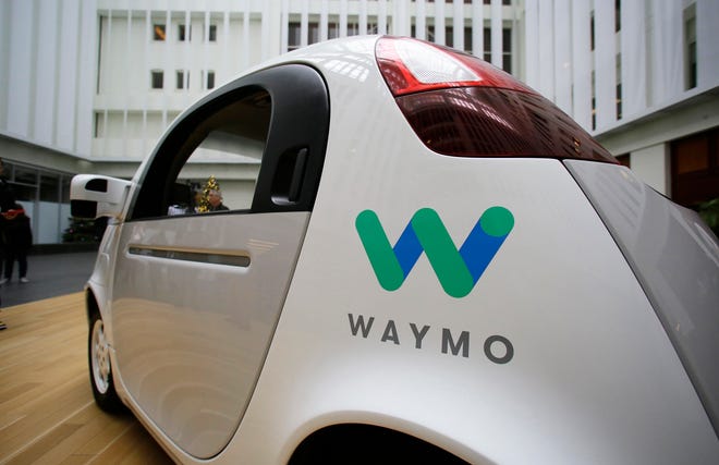 The Waymo driverless car is displayed during a Google event, Tuesday, Dec. 13, 2016, in San Francisco. The self-driving car project that Google started seven years ago has grown into a company called Waymo. The new identity announced Tuesday marks another step in an effort to revolutionize the way people get around. Instead of driving themselves, people will be chauffeured in robot-controlled vehicles if Waymo, automakers and ride-hailing service Uber realize their vision within the next few years. (AP Photo/Eric Risberg)