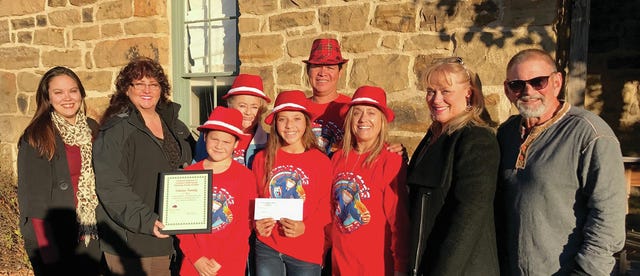 The Giovanie Soliano family won first place and $300 in Saturday’s Parade of Lights. From left, Reba Bueno, Chamber secretary, Tami Garcia, Tri-County Tech, A.J. Soliano, Tedisue Witcraft, Kimberly Witcraft Soliano, Giovanie Soliano, Cindy Helmer, Tri-County Tech, and Mark Helmer, Chamber.