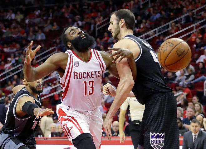 The Houston Rockets’ James Harden (13) is fouled by the Sacramento Kings’ Kosta Koufos during the second half of a game Wednesday in Houston. The Rockets won 132-98. (David J. Phillip/AP Photo)