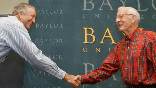 Baylor University President Robert B. Sloan shakes hands with board of regents Chairman Will Davis during a news conference in 2004 in Waco.