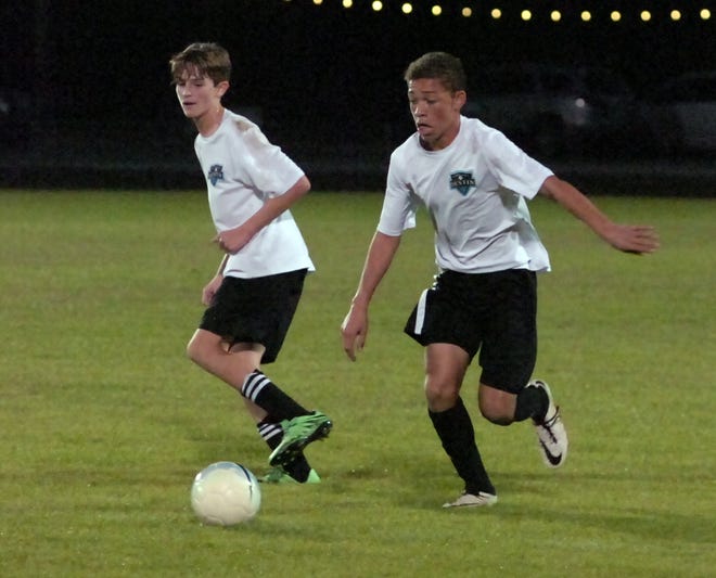 Destin's Carson Hickok (right) makes a move on the ball. Hickok scored two goals in the 3-0 win over the Meigs Wildcats. TINA HARBUCK/THE LOG
