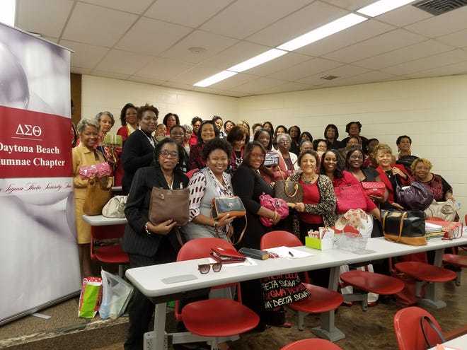 Members of the Daytona Beach Alumnae Chapter of Delta Sigma Theta Sorority and representatives from the women shelters show the filled purses collected in the Delta Purse program. Photo provided