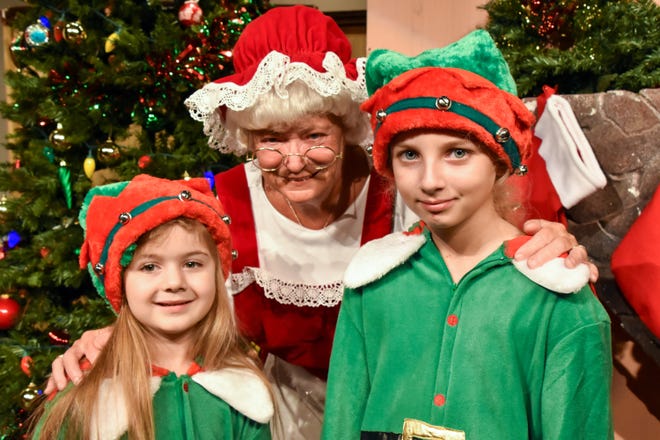 Lila Gay, left, and Ivy Lee, right, portray elves alongside Glenna Walkden as Mrs. Claus in Daytona Playhouse's "'Twas the Night Before Christmas." MIKE KITAIF