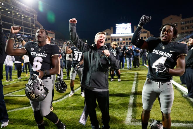 In this Nov. 19, 2016, file photo, from left, Colorado Buffaloes wide receiver Johnny Huntley III (6) sings the school song with head coach Mike MacIntyre and defensive back Chidobe Awuzie (4) after defeating Washington State 38-24 in Boulder, Colo. Colorado’s Mike MacIntyre is The Associated Press College Football Coach of the Year after leading the Buffaloes to a 10-3 record and their first bowl game since 2007. In four years, MacIntyre’s turned a program that was regarded as one of the nation’s worst into a Pac-12 title contender. (David Zalubowski/AP File Photo)