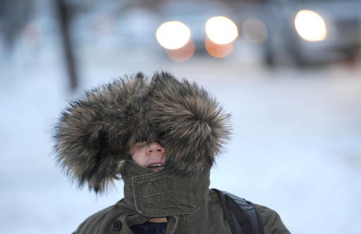 Kasim Kantarevic, 12, keeps his hood up as he walks to school on Thursday, Dec. 15, 2016 in Erie, Pa. Much of the northern Mid-Atlantic and Northeast will stay cold for the next couple of days as the arctic air remains stuck over the northern Appalachians, the National Weather Service said. (Christopher Millette/Erie Times-News via AP)