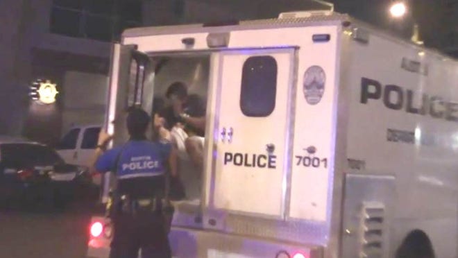 Screenshot from Peaceful Streets Project video. Austin police launched an internal investigation after local group Peaceful Streets Project released a video showing a downtown police officer pepper-spraying a man who was sitting inside a police van on the early morning of Thursday, March 17, 2016.