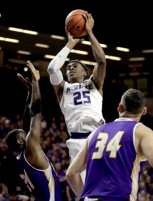 Kansas State’s Wesley Iwundu, middle, is averaging 12.1 points, 5.8 rebounds and 3.5 assists this season. (The Associated Press)