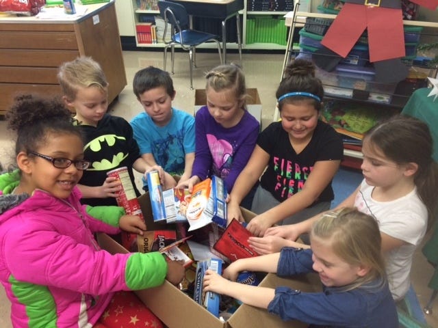 Second-graders at Claymont Elementary recently packed a box with 41 pounds of goodies to ship to an American serviceman serving abroad. Students from Debbie Keathley's class, working with Joyce Mehok, loaded the box of Christmas cheer that was mailed to Ryan Garabrandt, a member of the United States Air Force who is working at a hospital in Afghanistan.