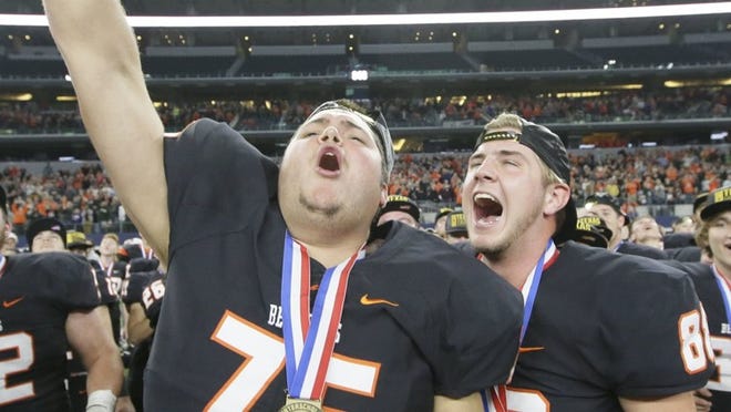 Aledo teammates Mason Jackson (76) and Jacob Arizpe (88) celebrate the Bearcats’ victory over Corpus Christi Calallen in the Class 5A, Division II state championship game. With its 24-16 triumph Friday night at AT&T Stadium in Arlington, Aledo won its seventh UIL football championship, one shy of the record shared by Katy, Southlake Carroll and Celina. (AP Photo/LM Otero)