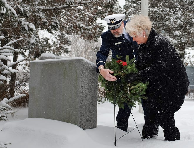 Carol Norton places a wreath with the help of Harold Jamieson of the U.S. Coast Guard Auxiliary during a Wreaths Across America ceremony at Albacore Park on Saturday. Norton is the daughter of Fred Philips Abrams, a civilian inspector for Portsmouth Naval Shipyard who died when USS Thresher sank in 1963. Photo by Ioanna Raptis/Seacoastonline