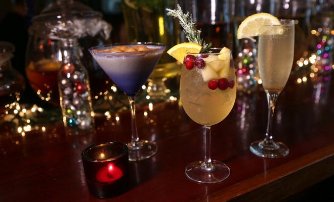 Holiday drinks at The Vintage, 837 Lincoln St., include, from left, a Pumpkin Spiced Martini, the sangria-based Mistletoe and the Champagne-based French 75. (Kelly Lyon/The Register-Guard)