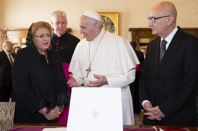 Pope Francis receives the President of Malta, Marie Louise Coleiro Preca, left, and her husband Edgar, right, during a private audience at the Vatican, Saturday, Dec. 17, 2016. (Claudio Peri/ANSA Pool via AP)