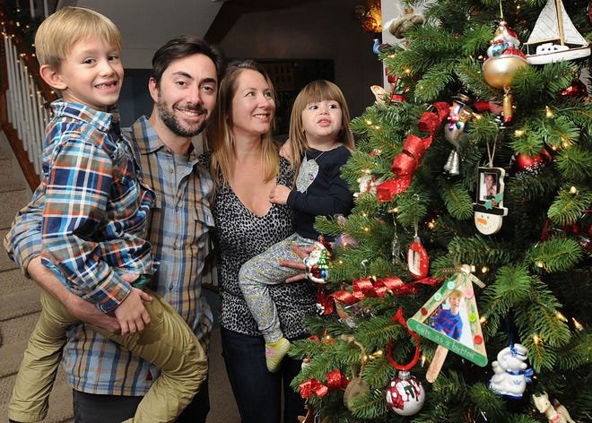 Michael Cosdon, with (from left) son Dashiell, 6, wife Genevieve, and daughter Margaux, 3, bought an artificial Christmas tree after years of suffering through allergies unknowingly caused by mold that can be found on evergreens.