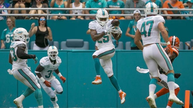 Miami Dolphins cornerback Xavien Howard (25), can't bring down an interception of a Cleveland Browns quarterback Cody Kessler (6) pass during fourth quarter action Sunday September 25, 2016 at Hard Rock Stadium in Miami Gardens. (Bill Ingram / The Palm Beach Post)
