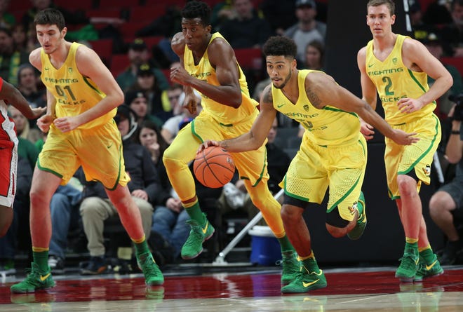 Oregon's Tyler Dorsey (second from right) leads his teammates down court after forcing a turnover against UNLV at the Moda Center in Portland. (Chris Pietsch/The Register-Guard)