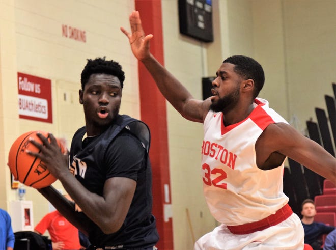 New Hampshire forward Iba Camara, left, works against Boston University's Juston Alston during their game at Case Gym in Boston on Sunday.
Photo by Mike Zhe/Seacoastonline