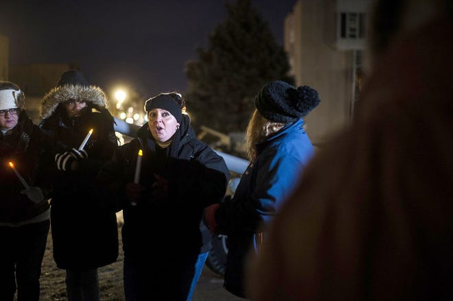 Brooke Bailey of Manito speaks to a crowd gathered outside the Tazewell County Courthouse in Pekin for a vigil Saturday night. The vigil was for Robert Bee Jr., of Pekin, who has been missing for a month. People who attended the vigil were encouraged to bring coats, hats and gloves for distribution to needy children, and area residents have been asked to display yellow lights on their porches to indicate the home is a safe haven for Bee to come to. LEWIS MARIEN / GATEHOUSE MEDIA ILLINOIS
