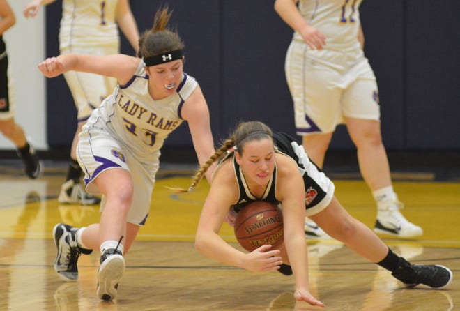 Newmarket's Reagan Jordan, right, dives for a loose ball with Nute's Shannon St. Lawrence during Division IV action Monday in Portsmouth at Great Bay Community College. Photo by Mike Whaley/Fosters.com