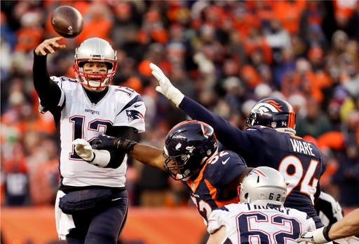 New England Patriots quarterback Tom Brady passes under pressure against the Denver Broncos during the second half of an NFL football game Sunday, Dec. 18, 2016, in Denver. (AP Photo/Jack Dempsey)