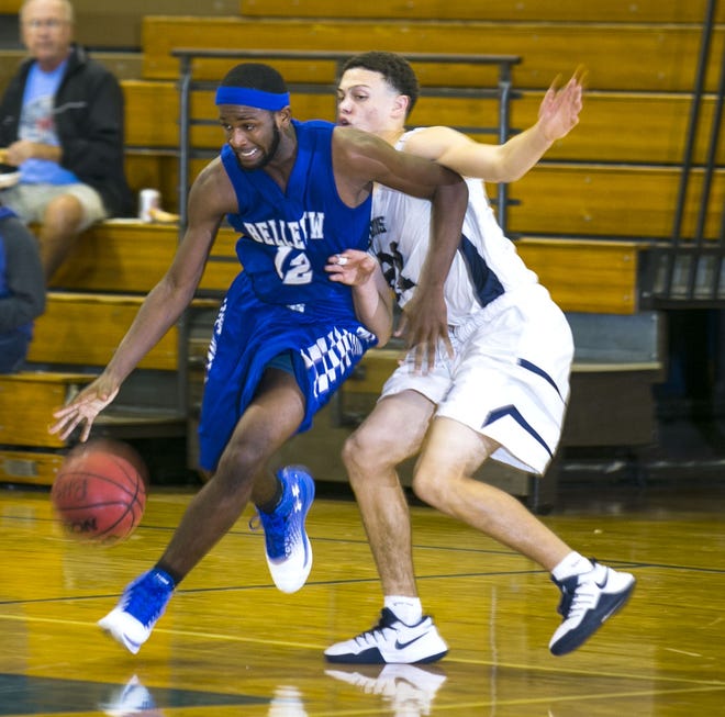 Belleview's Jalen Smith drives past Lake Nona's Xavier Rodriguez in the Zaxby Winter Shootout on Tuesday at Belleview High School. The Lions beat the Rattlers 68-43. MORE PHOTOS AT OCALA.COM (Cyndi Chambers/Correspondent)